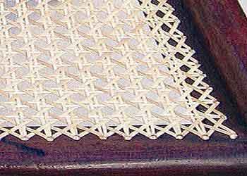 A close up picture of criss-crossed caning on a dining room style chair.