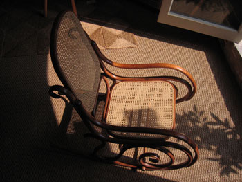 This shows the end result - the fully
reconstructed rocking chair, its mahogany wood glowing and its panels
beautifully recaned.